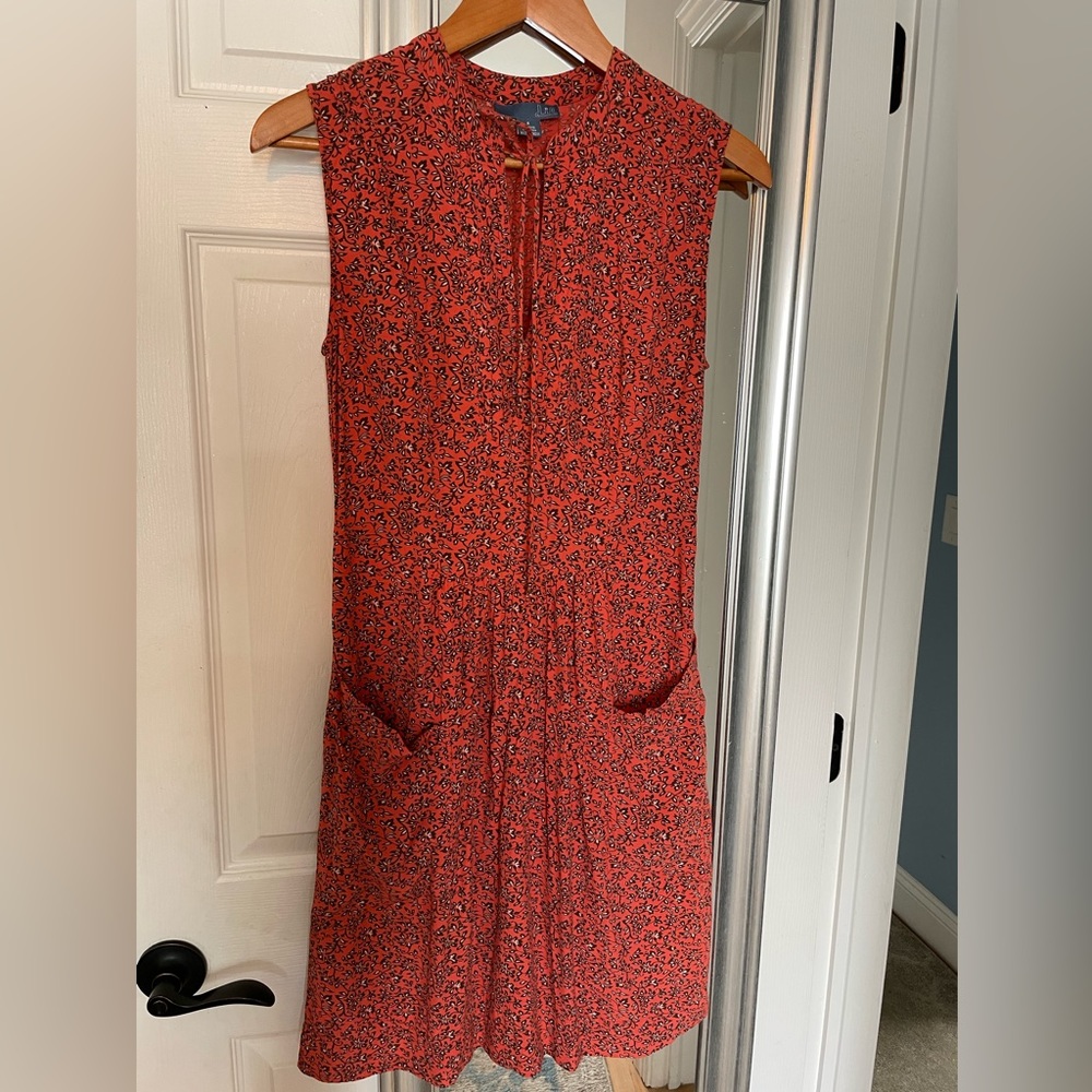 Mid length sleeveless dress.